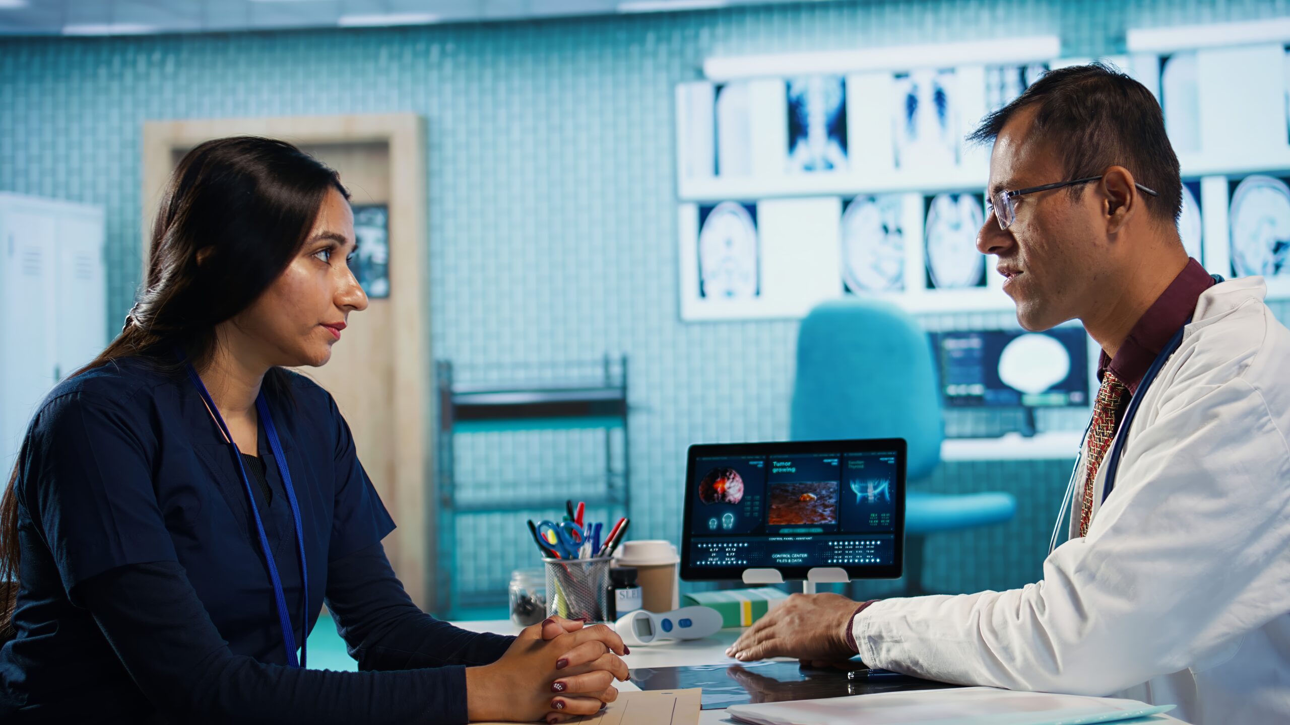 Physician meeting with patient to discuss medical test results in cabinet