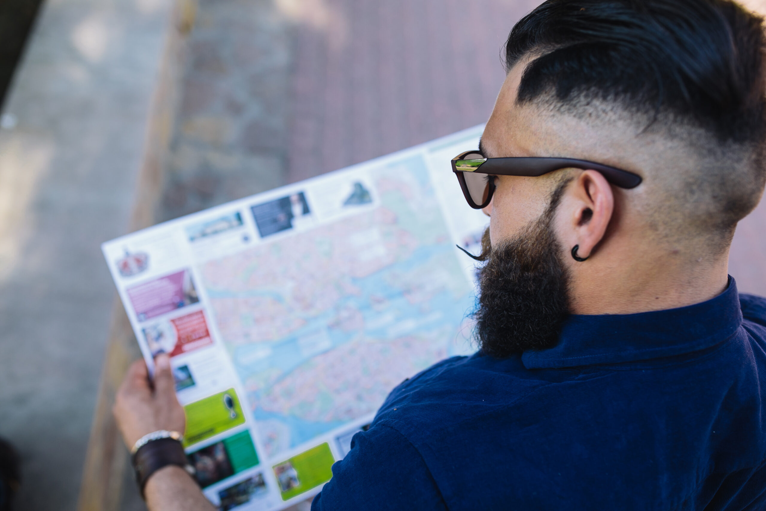 bearded man sitting and looking at a map